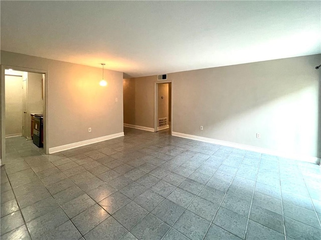 222 London Ave Unit 106, Metairie, LA 70005 - unfurnished room with baseboards and dark tile patterned floors
