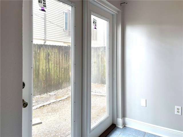 222 London Ave Unit 106, Metairie, LA 70005 - doorway with light tile patterned floors and baseboards