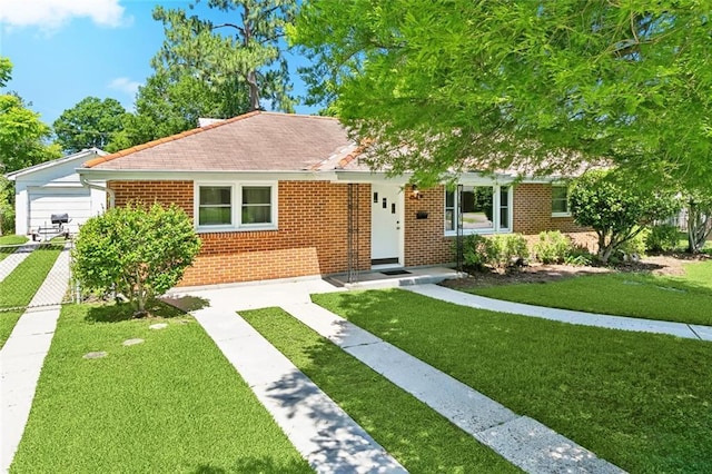 16 Ravan Ave, Harahan, LA 70123 - view of front of property featuring brick siding, a front yard, and roof with shingles