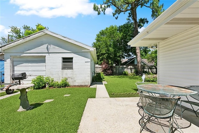 16 Ravan Ave, Harahan, LA 70123 - view of yard featuring a patio area, a garage, and outdoor dining area