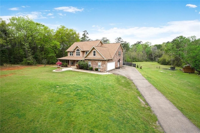 60 Bleu Lake Dr, Covington, LA 70435 - view of front of house featuring asphalt driveway, a front yard, an attached garage, and brick siding