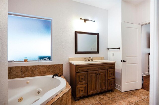 60 Bleu Lake Dr, Covington, LA 70435 - bathroom featuring vanity, tile patterned floors, and a whirlpool tub
