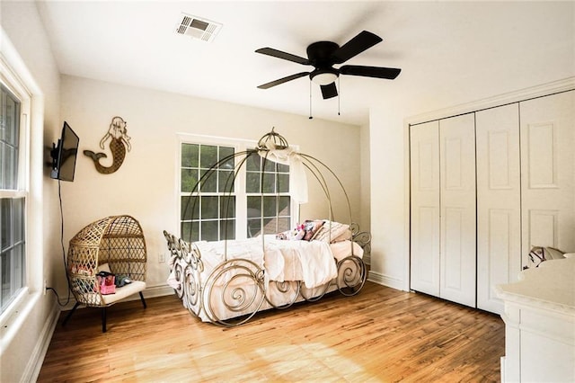 60 Bleu Lake Dr, Covington, LA 70435 - bedroom featuring light wood-type flooring, a closet, baseboards, and a ceiling fan