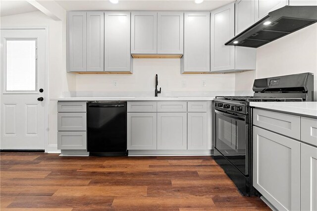 2122 N Butterfly Cir, Terrytown, LA 70056 - kitchen with black appliances, ventilation hood, a sink, light countertops, and dark wood finished floors