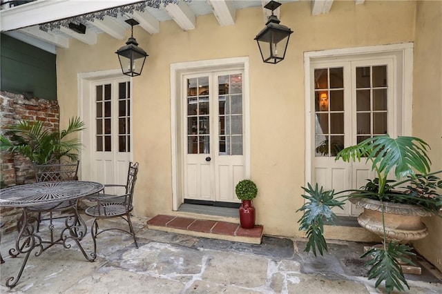 532-38 Governor Nicholls St, New Orleans, LA 70116 - property entrance featuring stucco siding, a patio, and french doors