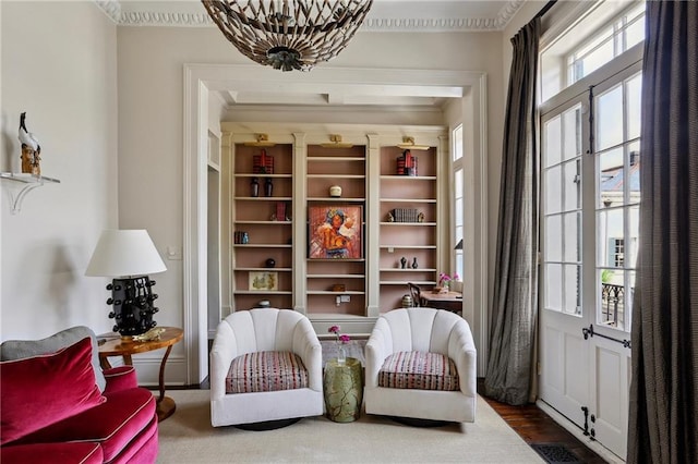 532-38 Governor Nicholls St, New Orleans, LA 70116 - living area featuring ornamental molding, wood finished floors, and a chandelier