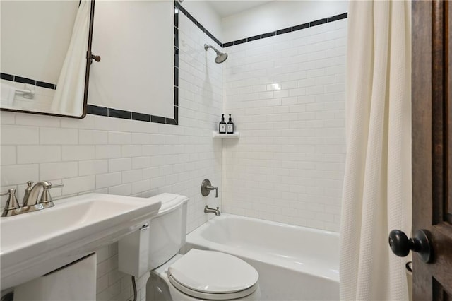 532-38 Governor Nicholls St, New Orleans, LA 70116 - bathroom featuring shower / tub combo with curtain, tile walls, toilet, a sink, and decorative backsplash