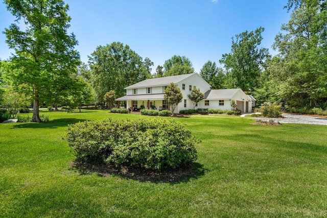 4 Riverdale Dr, Covington, LA 70433 - view of front of home with a front yard, view of scattered trees, and a garage