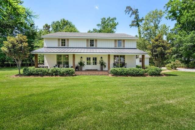 4 Riverdale Dr, Covington, LA 70433 - view of front of property with french doors, a front yard, covered porch, and a standing seam roof