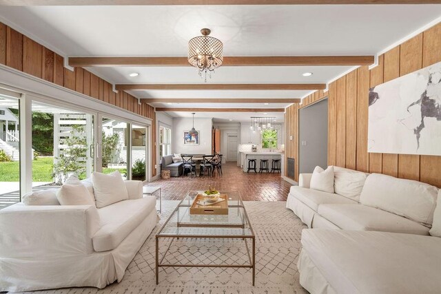 4 Riverdale Dr, Covington, LA 70433 - living area featuring a chandelier, beamed ceiling, and wooden walls