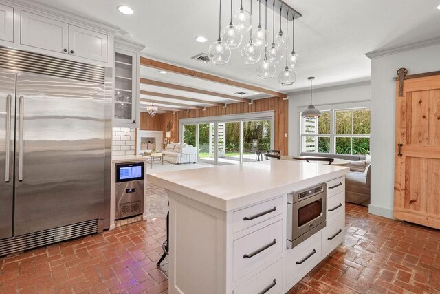 4 Riverdale Dr, Covington, LA 70433 - kitchen with built in appliances, brick floors, recessed lighting, white cabinetry, and open floor plan