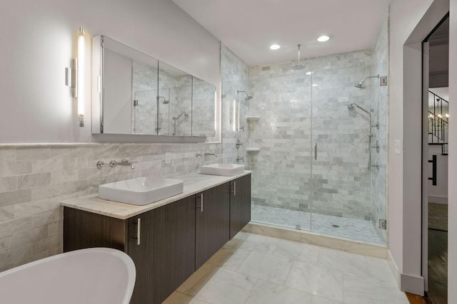4 Riverdale Dr, Covington, LA 70433 - bathroom featuring a stall shower, tile walls, a soaking tub, double vanity, and recessed lighting