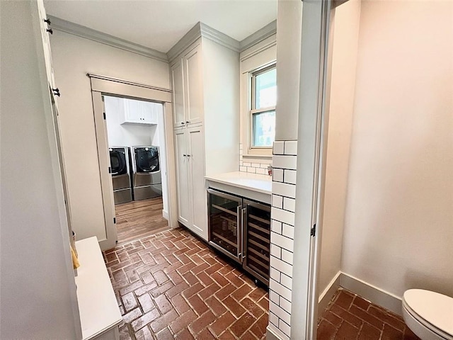 4 Riverdale Dr, Covington, LA 70433 - bathroom featuring brick floors, independent washer and dryer, vanity, crown molding, and baseboards