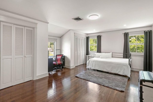 4 Riverdale Dr, Covington, LA 70433 - bedroom featuring crown molding, two closets, wood finished floors, a desk, and baseboards