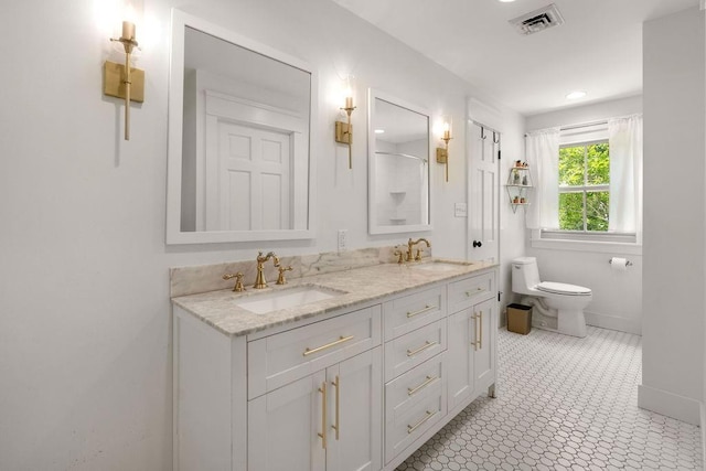 4 Riverdale Dr, Covington, LA 70433 - bathroom with toilet, double vanity, and baseboards