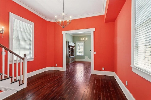 530 Spain St, New Orleans, LA 70117 - unfurnished dining area featuring a chandelier, crown molding, wood-type flooring, stairs, and baseboards