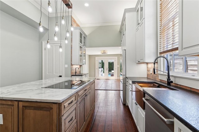 530 Spain St, New Orleans, LA 70117 - kitchen featuring stainless steel appliances, french doors, ornamental molding, white cabinets, and a sink