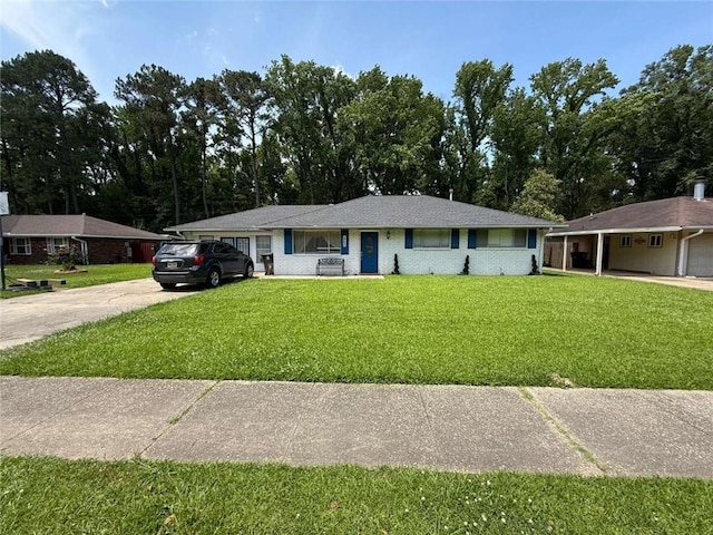 9425 Dancy Ave, Baton Rouge, LA 70814 - ranch-style home featuring driveway, a front lawn, and view of scattered trees