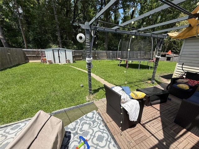 9425 Dancy Ave, Baton Rouge, LA 70814 - view of yard with a trampoline, a storage unit, an outdoor structure, and a pergola