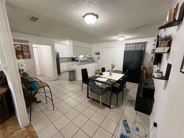 9425 Dancy Ave, Baton Rouge, LA 70814 - dining space with a textured ceiling and light tile patterned floors