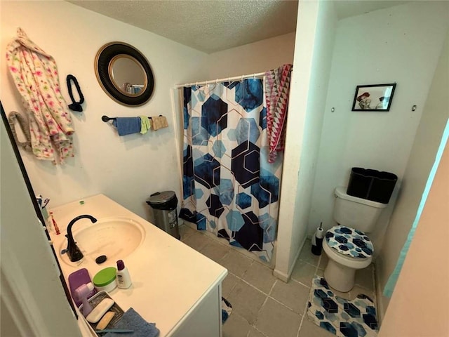 9425 Dancy Ave, Baton Rouge, LA 70814 - bathroom with tile patterned floors, a textured ceiling, toilet, vanity, and curtained shower