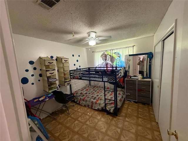 9425 Dancy Ave, Baton Rouge, LA 70814 - bedroom featuring a textured ceiling, light floors, a ceiling fan, and a closet