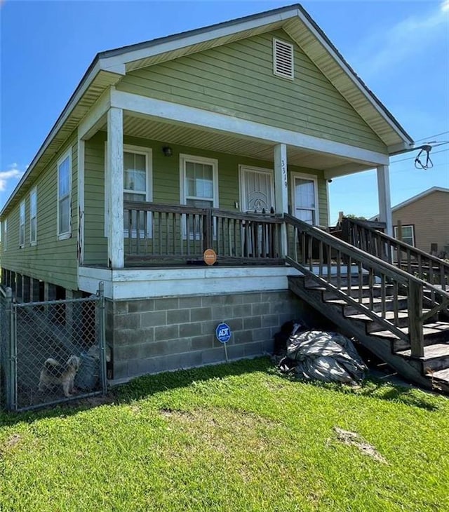 3319 N Dorgenois St, New Orleans, LA 70117 - view of front of house featuring a porch, a front lawn, and stairway