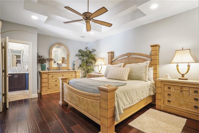 bedroom with a raised ceiling, dark wood-type flooring, recessed lighting, baseboards, and a ceiling fan
