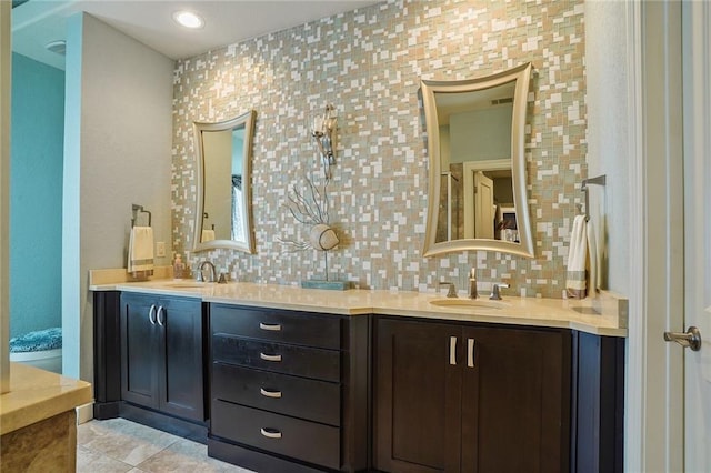 full bathroom featuring backsplash, double vanity, and tile patterned flooring