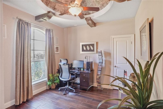 home office with dark wood finished floors, a ceiling fan, baseboards, and beam ceiling