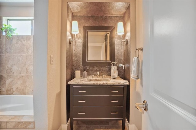 bathroom featuring vanity and a tub to relax in