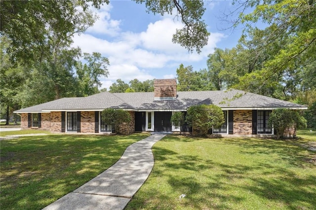 single story home with a front yard and a chimney