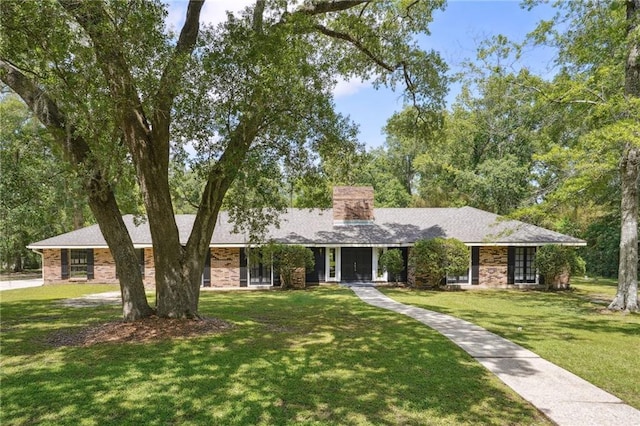 ranch-style house with a front lawn and a chimney