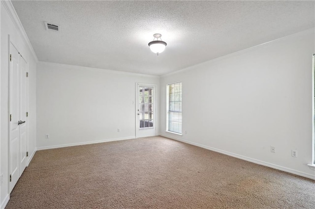 unfurnished bedroom featuring crown molding, carpet, a textured ceiling, and baseboards