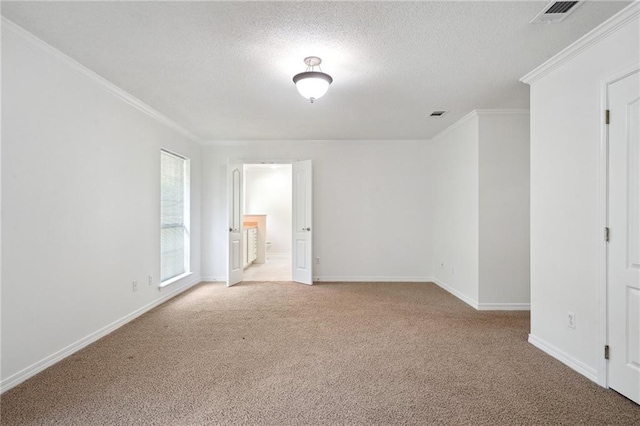 unfurnished room with light colored carpet, ornamental molding, baseboards, and a textured ceiling