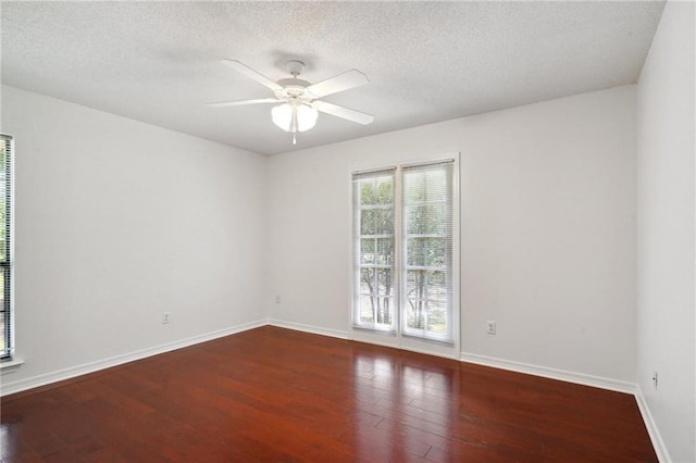 unfurnished room featuring ceiling fan, baseboards, wood finished floors, and a textured ceiling