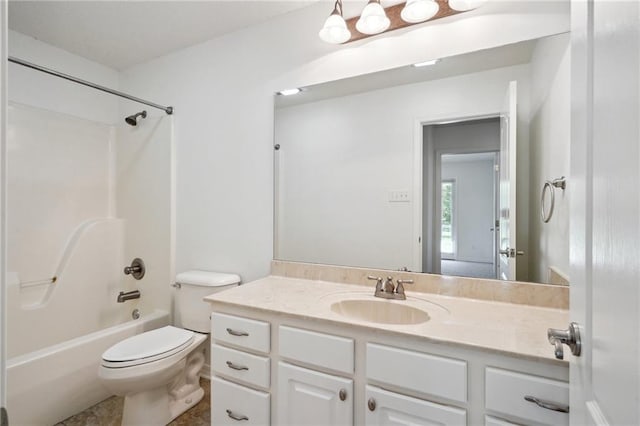 full bathroom with toilet, vanity, and shower / washtub combination