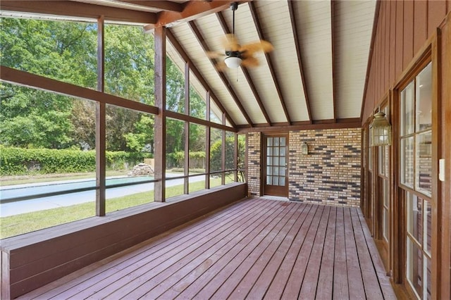 unfurnished sunroom featuring hardwood / wood-style floors and ceiling fan