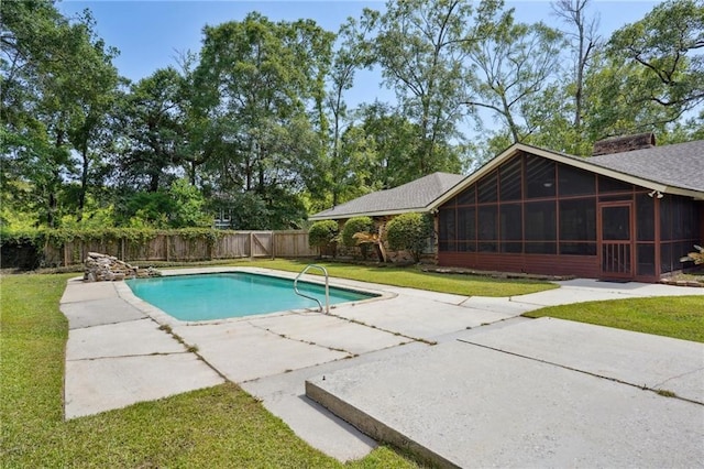 view of swimming pool with a patio and a sunroom