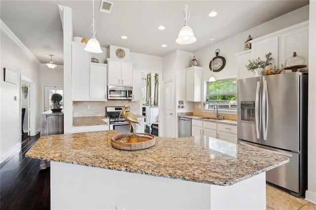 28591 Water Oak Loop, Ponchatoula, LA 70454 - kitchen with appliances with stainless steel finishes, white cabinetry, light stone countertops, backsplash, and recessed lighting
