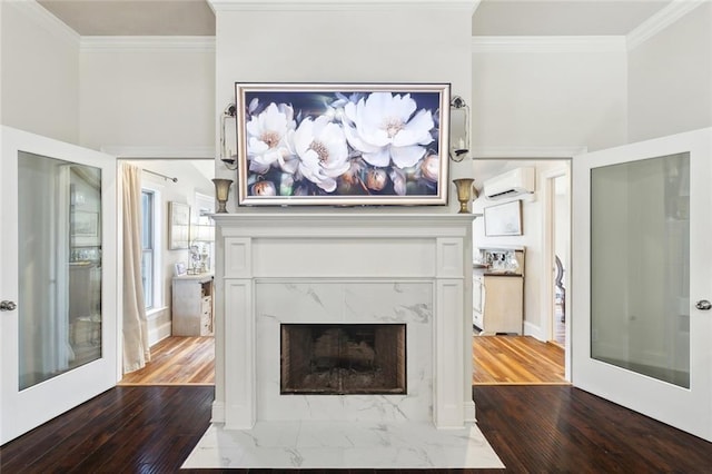 28591 Water Oak Loop, Ponchatoula, LA 70454 - unfurnished living room featuring a wall unit AC, dark wood-type flooring, ornamental molding, and a premium fireplace