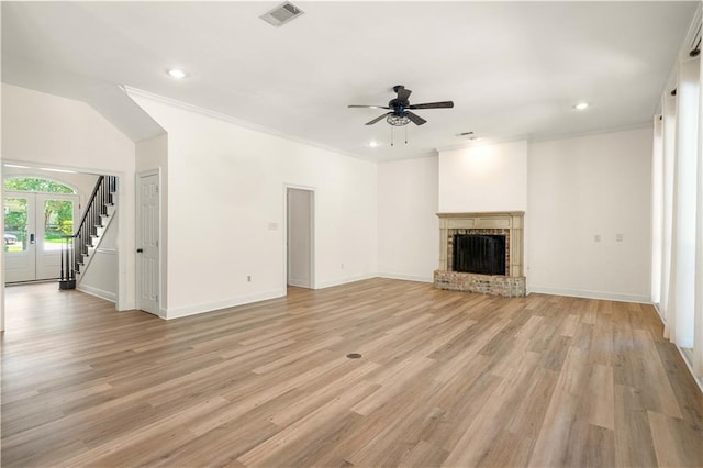125 Bent Tree Ct, Covington, LA 70433 - unfurnished living room featuring ceiling fan, stairway, a fireplace, light wood-style flooring, and baseboards