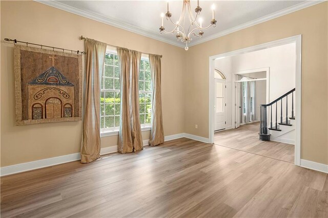 125 Bent Tree Ct, Covington, LA 70433 - spare room featuring a chandelier, ornamental molding, wood finished floors, baseboards, and stairway