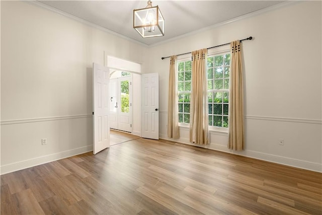 125 Bent Tree Ct, Covington, LA 70433 - spare room featuring ornamental molding, wood finished floors, a chandelier, and baseboards