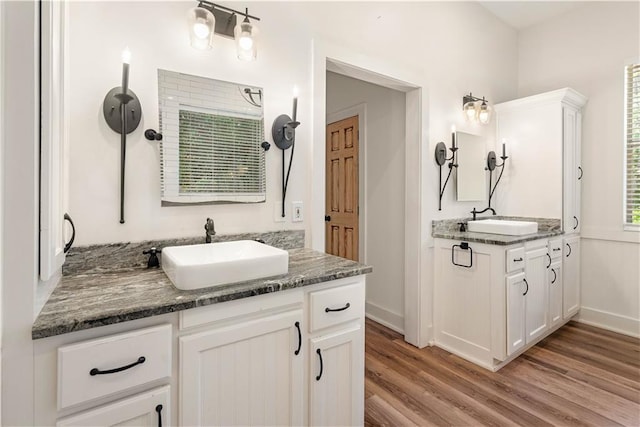 125 Bent Tree Ct, Covington, LA 70433 - bathroom with wood finished floors, baseboards, and two vanities