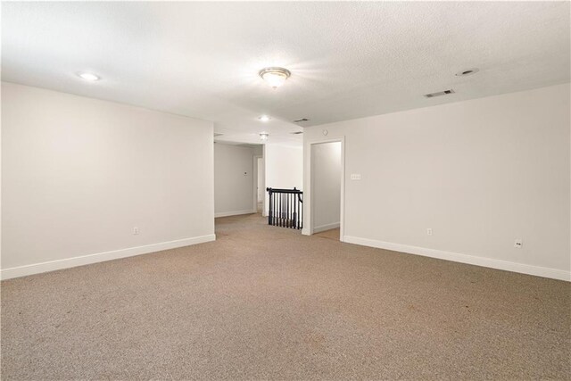 125 Bent Tree Ct, Covington, LA 70433 - unfurnished room featuring light carpet, baseboards, and a textured ceiling