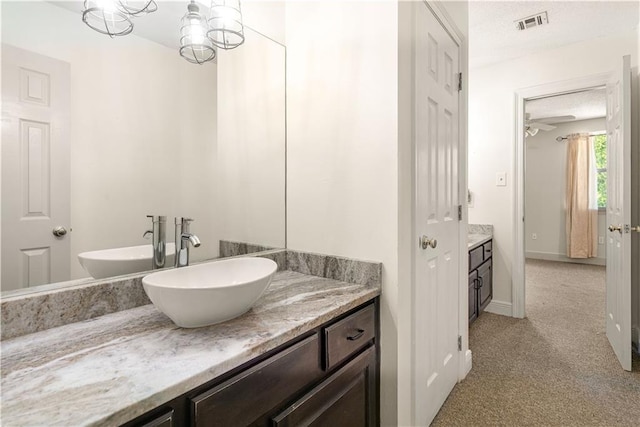125 Bent Tree Ct, Covington, LA 70433 - bathroom with vanity, a textured ceiling, and baseboards
