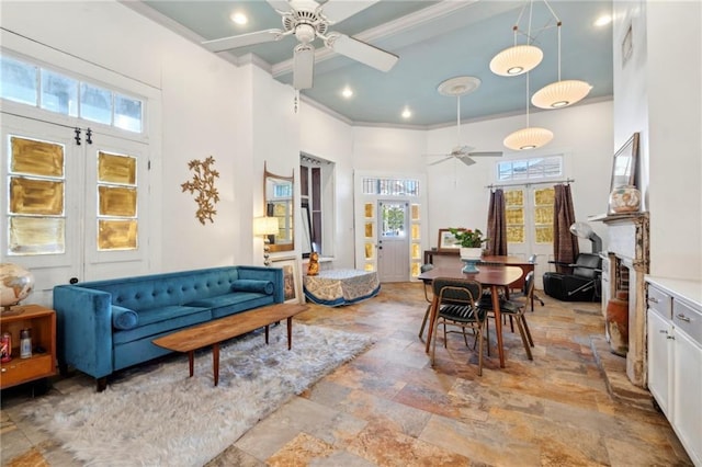 2000 St Philip St, New Orleans, LA 70116 - living room featuring a ceiling fan, a high ceiling, light stone finish floors, ornamental molding, and recessed lighting