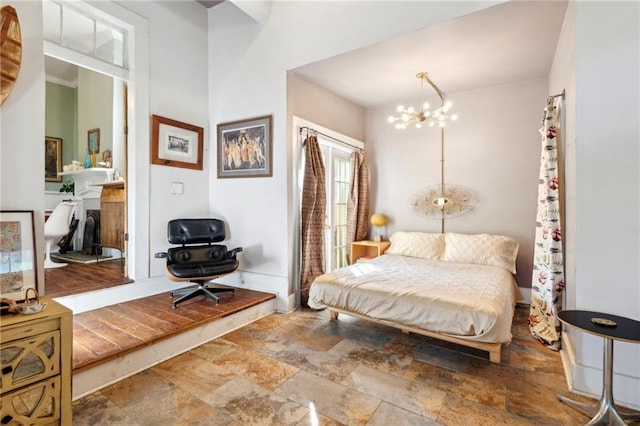 2000 St Philip St, New Orleans, LA 70116 - bedroom featuring stone finish floors and a chandelier