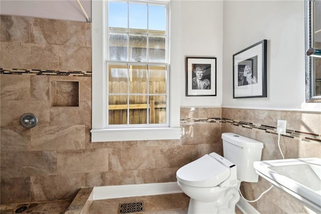 2000 St Philip St, New Orleans, LA 70116 - full bath with toilet, a tile shower, and wainscoting